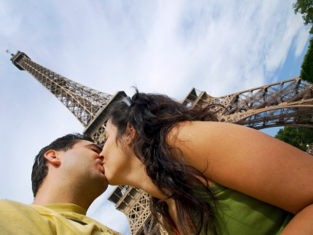 Couple Kisses in front of Eiffel Tower