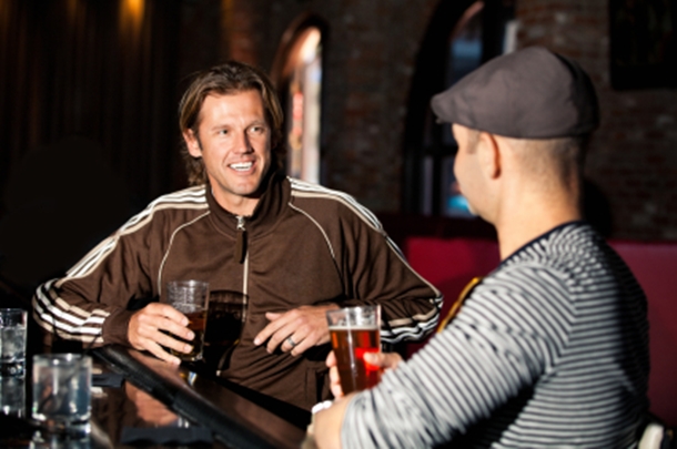 Two Men Talking at a Bar