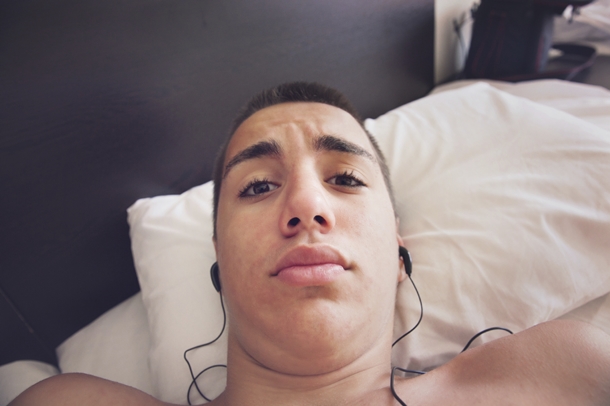Man Taking Selfie in Bed