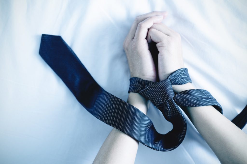Woman's Wrists Tied with Man's Tie
